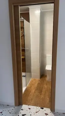 a bathroom with a toilet and a glass door at Del Mar 1C - New Beach First floor One bed flat in Puerto de Sagunto