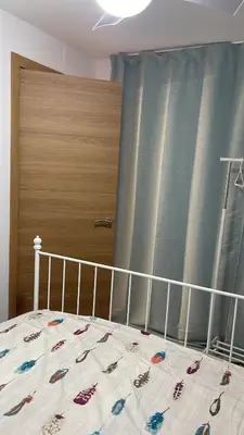 a bedroom with a bed with a crib and a window at Del Mar 1C - New Beach First floor One bed flat in Puerto de Sagunto