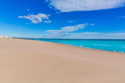 a sandy beach with the ocean in the background at Del Mar 1C - New Beach First floor One bed flat in Puerto de Sagunto