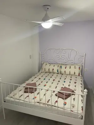 a white bed with a ceiling fan in a bedroom at Del Mar 1C - New Beach First floor One bed flat in Puerto de Sagunto