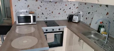 a kitchen with a counter with a microwave and a sink at Del Mar 1C - New Beach First floor One bed flat in Puerto de Sagunto