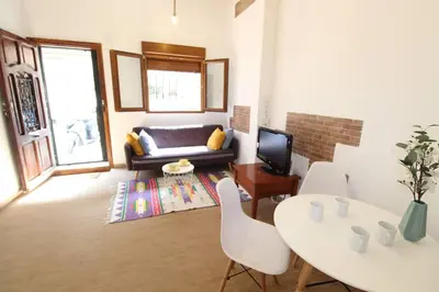 a living room with a couch and a table at Casa típica del Cabanyal in Valencia