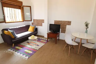 a living room with a couch and a table at Casa típica del Cabanyal in Valencia