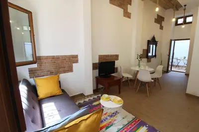 a living room with a couch and a table at Casa típica del Cabanyal in Valencia
