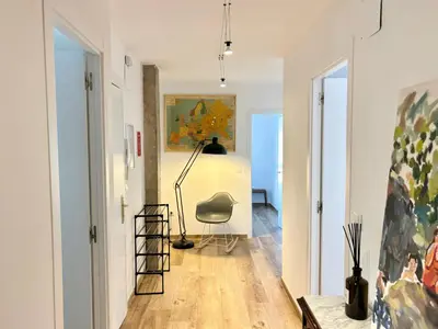 a room with a chair and a painting on the wall at Apartamento artístico en el centro de Segorbe in Segorbe