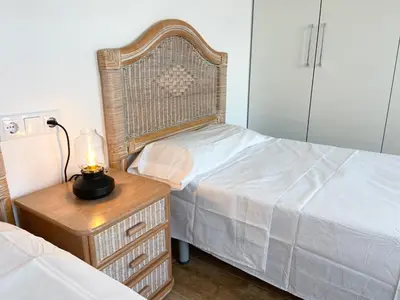 a bedroom with a bed and a lamp on a night stand at Apartamento artístico en el centro de Segorbe in Segorbe