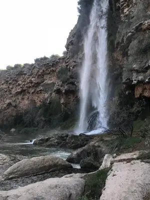 a waterfall on the side of a mountain at Apartamento artístico en el centro de Segorbe in Segorbe