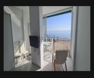 a room with a balcony with a view of the ocean at Edificio El Sol in Cullera