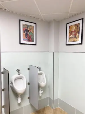 a bathroom with two urinals and a sink at The POD Suite Hostel Blasco in Valencia