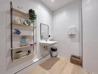 a bathroom with a sink and a mirror and a shower at The POD Suite Hostel Blasco in Valencia