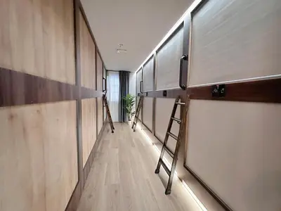 a long hallway with shelves and a ladder at The POD Suite Hostel Blasco in Valencia