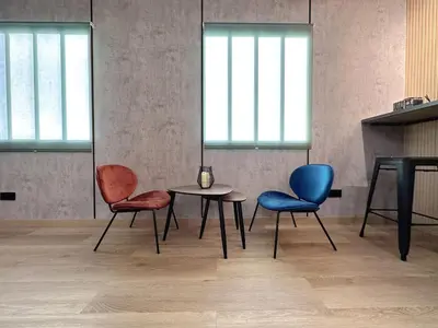 two chairs and a table in a room at The POD Suite Hostel Blasco in Valencia