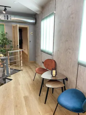 a room with two chairs and a table and a window at The POD Suite Hostel Blasco in Valencia