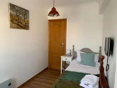 a bedroom with a bed and a television in it at Sueca 1 in Sueca