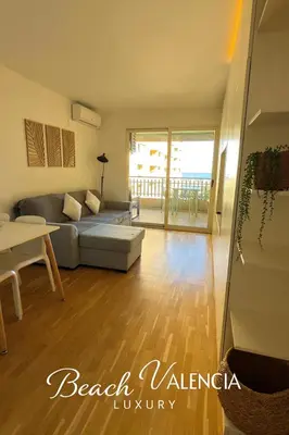 a living room with a couch and a table at BEACH VALENCIA LUXURY B7-23 Apartment with terrace and sea views in Valencia
