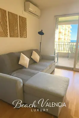 a living room with a couch and a balcony at BEACH VALENCIA LUXURY B7-23 Apartment with terrace and sea views in Valencia