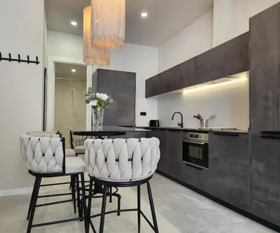 a kitchen with two white chairs and a table at MD Pare Presentat in Valencia