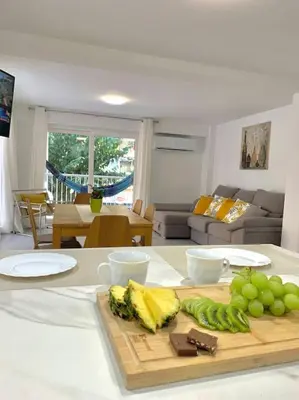 a kitchen counter with a cutting board with green grapes at NEW STYLISH BEACH FRONT APARTMENT in Cullera