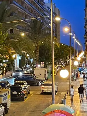 a city street at night with cars parked on the street at NEW STYLISH BEACH FRONT APARTMENT in Cullera