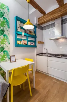 a kitchen with a white table and yellow chairs at RUZAFA COOL LOFT in Valencia