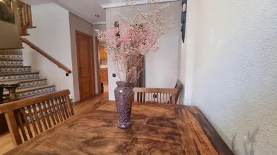 a vase with flowers sitting on a wooden table at Zanzibar Beach Puzol relax en la playa cerca de Sagunto y Valencia in Puzol