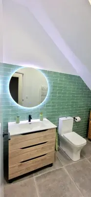 a bathroom with a sink and a toilet and a mirror at Loft el Baix - Cullera in Cullera