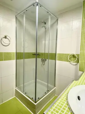 a glass shower in a bathroom with a sink at Sol y Mar in Puebla de Farnals
