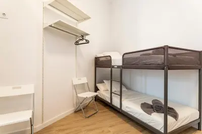 a room with two bunk beds and a mirror at 10 pax, AC, Wifi gratis, Ciudad Artes y Ciencias in Valencia