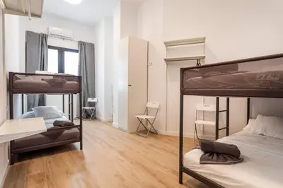 a room with two bunk beds and a wooden floor at 10 pax, AC, Wifi gratis, Ciudad Artes y Ciencias in Valencia
