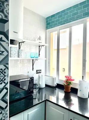 a kitchen with a black counter top with a microwave at 3-bedroom apartment with terrace on ground floor in Moncófar