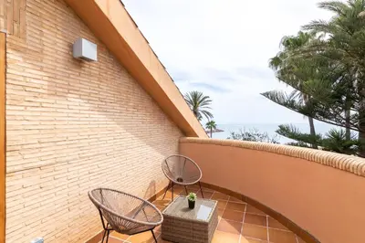 a patio with two chairs and a table on a building at Dolce Vita B&B - Only Adults in Valencia