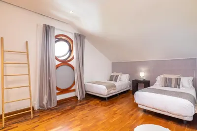 a bedroom with two beds and a large window at Dolce Vita B&B - Only Adults in Valencia