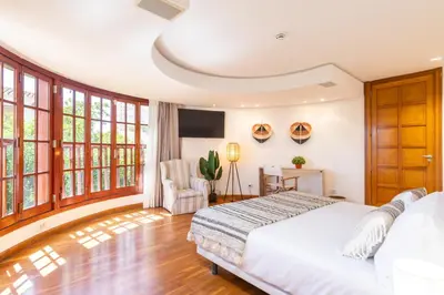 a bedroom with a large white bed and windows at Dolce Vita B&B - Only Adults in Valencia