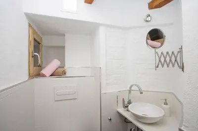 a white bathroom with a sink and a mirror at Next to Central Market, Cathedral and Town Hall in Valencia