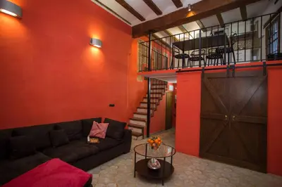 a living room with a couch and a barn door at Next to Central Market, Cathedral and Town Hall in Valencia