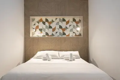a bedroom with a white bed with two white towels at Victoria Inn Apartment in Valencia