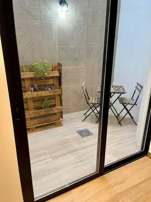 a room with a glass door with a table and chairs at Victoria Inn Apartment in Valencia