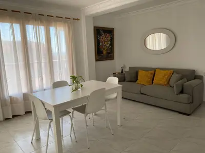 a living room with a table and chairs and a couch at Brisa Marina in Las Canteras