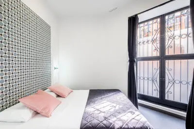 a bedroom with a bed and a large window at New and Modern Apartment with Comfy Beds in Valencia