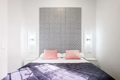 a bedroom with a bed with two pink pillows at New and Modern Apartment with Comfy Beds in Valencia