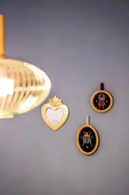 three ornaments with a heart on a wall at Charming and Comfortable Apartment with Inviting Atmosphere in Valencia