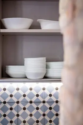 a shelf with plates and bowls on it at Charming and Comfortable Apartment with Inviting Atmosphere in Valencia