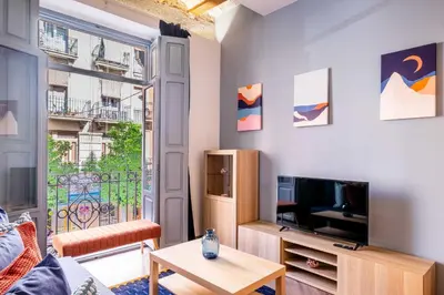 a living room with a tv and a table at Beautiful Suite with Private Terrace in Valencia