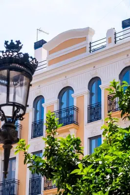 a yellow building with blue windows and a street light at Classy Studio Apartment with Unique Design in Valencia