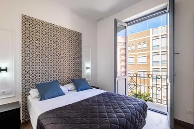 a bedroom with a bed and a large window at Well Lit and Creatively Designed Apartment in Valencia