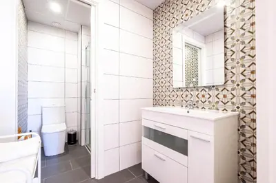a bathroom with a sink and a mirror at Well Lit and Creatively Designed Apartment in Valencia