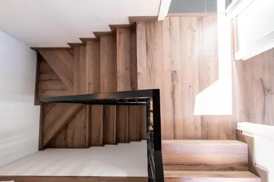a staircase in a house with a wooden wall at Spacious Penthouse with Massive Terrace in Valencia