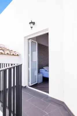 a sliding glass door leading into a bedroom with a bed at Spacious Penthouse with Massive Terrace in Valencia