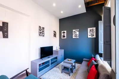 a living room with a couch and a tv at Spacious Penthouse with Massive Terrace in Valencia