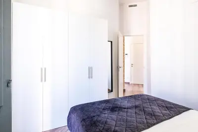 a bedroom with white cabinets and a bed at BrightHouse with Warm and Friendly Vibes in Valencia
